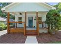 Delightful front porch with wooden accents, offering a cozy entrance to the home at 5 Windsor Ter, Avondale Estates, GA 30002