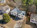 Aerial view showcasing the home's position within a quiet neighborhood setting surrounded by mature trees at 239 Taylors Farm Drive Dr, Canton, GA 30115