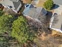 Overhead view of the house surrounded by lush greenery and neighboring homes in a serene community at 239 Taylors Farm Drive Dr, Canton, GA 30115