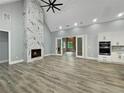 Spacious living room with hardwood floors, a marble fireplace, and sliding glass doors to the outdoor area at 244 Coastline Road Rd, Fayetteville, GA 30214