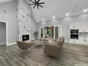 Bright living room with fireplace, high ceilings, and view to a covered patio through sliding glass doors at 244 Coastline Road Rd, Fayetteville, GA 30214