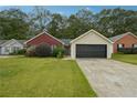 Charming single-story home with brick and siding, a well-manicured lawn, and an attached two-car garage at 11529 Vinea Ln, Hampton, GA 30228