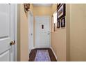 Hallway with dark wood floors, neutral walls, and white doors adding to the space's elegance at 220 Renaissance Ne Pkwy # 1115, Atlanta, GA 30308