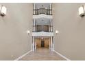 Stunning multi-level hallway featuring hardwood floors, recessed lighting, and unique architectural design at 220 Renaissance Ne Pkwy # 1115, Atlanta, GA 30308