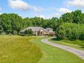 Beautiful brick home with mature trees and a long driveway set on a sprawling lot at 226 Euharlee Five Forks Rd, Kingston, GA 30145