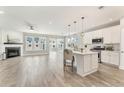 Open-concept living space with a fireplace and spacious white kitchen with stainless appliances at 242 Aspen Way, Dallas, GA 30157