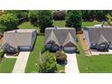 Aerial view of a brick home with a two-car garage, surrounded by well-manicured lawns and mature trees at 314 Santa Anita Ave, Woodstock, GA 30189