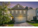 Inviting two-story home showcasing a two-car garage, complemented by a lush green lawn at 4406 Richmond Ct, Stone Mountain, GA 30083
