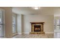 Living room featuring a stone fireplace, neutral paint, and large windows at 924 Park Gate Pl, Stone Mountain, GA 30083