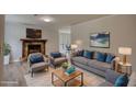 A spacious living room with a stone fireplace, grey sofa, and decoratively matched blue pillows at 924 Park Gate Pl, Stone Mountain, GA 30083
