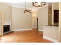 Open-concept living area with hardwood floors, fireplace, and connection to the kitchen at 1245 Mclendon Dr, Decatur, GA 30033