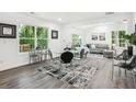 Open dining area with modern table, chairs, and natural light adjacent to a comfortable living space at 2160 Perkerson Sw Rd, Atlanta, GA 30315