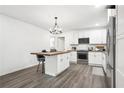 Modern kitchen features white cabinets, stainless appliances, and an island at 2160 Perkerson Sw Rd, Atlanta, GA 30315