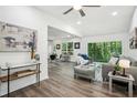 Bright living room with modern furnishings, hardwood floors, and large windows overlooking a lush backyard at 2160 Perkerson Sw Rd, Atlanta, GA 30315