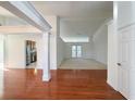 Bright, open-concept living room featuring hardwood floors, white columns and trim, and ample natural light at 2642 Colleen Ln, Dacula, GA 30019