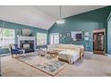 Bright living room with vaulted ceilings, fireplace, and stylish decor with lots of natural light from multiple windows at 4348 Tillage Path, Douglasville, GA 30135