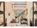 Elegant foyer with marble floors, staircase, and open view to the living area, creating a grand entrance at 5161 Hermitage Dr, Powder Springs, GA 30127
