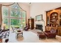 Bright living room with large windows, fireplace, and built-in shelves, offering a cozy and elegant space at 5161 Hermitage Dr, Powder Springs, GA 30127