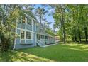 Stylish home with a well-maintained lawn, inviting porch, and mature trees enhancing its curb appeal at 800 Post Road Cir, Stone Mountain, GA 30088