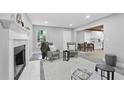 Bright living room with fireplace and open floor plan view of kitchen, with gray accent chairs at 800 Post Road Cir, Stone Mountain, GA 30088