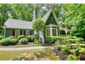 Attractive home with a manicured lawn, bay windows, and shutters, surrounded by lush trees at 2165 Robin Hood Trl, Cumming, GA 30040