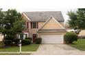 Two-story home features a two-car garage, front yard with mature landscaping, and a welcoming red front door at 3292 Shady Valley Ct, Loganville, GA 30052