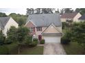 Aerial view of a two-story home featuring a two-car garage, and mature trees in a residential neighborhood at 3292 Shady Valley Ct, Loganville, GA 30052