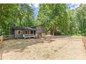 Exterior view of a cozy two-story home with fenced yard and an inviting fire pit area at 2642 Bridgehampton Sw Rd, Marietta, GA 30064