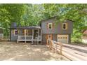 Two-story home with front porch and garage, featuring wood accents and a fenced yard at 2642 Bridgehampton Sw Rd, Marietta, GA 30064