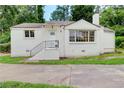 A charming one-story home features a white brick facade, front entrance staircase, and ample natural light at 2742 Alpine Rd, Atlanta, GA 30305