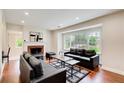 Bright living room featuring hardwood floors, fireplace, and a large window with natural light at 2742 Alpine Rd, Atlanta, GA 30305