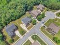 Aerial view of a suburban neighborhood featuring manicured lawns and mature trees at 271 Learwood Ln, Atlanta, GA 30349