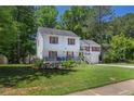 Charming two-story home featuring a covered front porch, red shutters, and a well-manicured lawn at 3856 Nowlin Nw Rd, Kennesaw, GA 30144