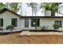 Charming home exterior with stone accents, newer landscaping, and a dark-colored front door at 396 Independence Dr, Jonesboro, GA 30238