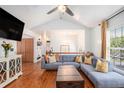 Inviting living room with vaulted ceilings, hardwood flooring, comfortable seating, and natural light at 6195 Queensdale Dr, Douglasville, GA 30135