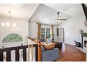 Bright living room boasting a vaulted ceiling, hardwood floors, and a large arched window at 6195 Queensdale Dr, Douglasville, GA 30135