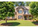 Charming brick home with a lush green lawn and mature trees in a desirable neighborhood at 2470 Anderson Estates Ct, Marietta, GA 30064