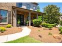 Inviting front porch with stone accents, manicured landscaping, and a cozy seating area at 2470 Anderson Estates Ct, Marietta, GA 30064