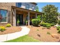 Welcoming front porch with stone accents, elegant pillars, and a manicured garden bed at 2470 Anderson Estates Ct, Marietta, GA 30064