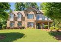 Elegant two-story home boasting a manicured lawn, complemented by lush landscaping and a welcoming front porch at 2470 Anderson Estates Ct, Marietta, GA 30064