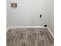 Laundry room with hardwood floors and white trim at 3530 Hopkins Ct, Powder Springs, GA 30127
