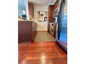 Kitchen featuring stainless steel appliances, wood cabinets, granite countertops, and wood flooring at 855 Peachtree Ne St # 1406, Atlanta, GA 30308