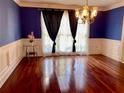 Elegant dining room with hardwood floors and wainscoting detail at 3120 Saint Andrews Cir, Duluth, GA 30096
