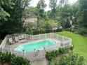 Backyard pool area with a white picket fence and well-manicured landscaping at 3120 Saint Andrews Cir, Duluth, GA 30096