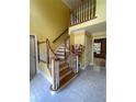 Bright foyer featuring a wood staircase with white railings and tile flooring at 3120 Saint Andrews Cir, Duluth, GA 30096