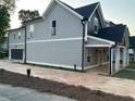 Exterior view of a well-maintained two-story home with a private driveway and lush greenery at 3189 Jackson, Hapeville, GA 30354