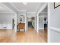 Bright foyer with hardwood floors, light gray walls, white trim, and elegant staircase at 3250 Cobbs Farm Nw Trl, Marietta, GA 30064