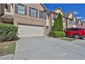 Well-maintained townhome features a large driveway, two-car garage, and lush landscaping for curb appeal at 328 Oaktown Ct, Lawrenceville, GA 30044