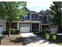 Attractive townhome showcasing a well-maintained lawn, neutral siding and a convenient driveway at 532 Oakside Pl, Acworth, GA 30102