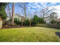 Spacious backyard featuring a well-maintained lawn, mature trees, and a wooden fence at 2603 Apple Valley Ne Rd, Brookhaven, GA 30319
